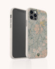 The Jasmine Eco-Friendly Phone Case features a soft, light beige border and botanical floral motifs in muted green, pink, and yellow. The phone case stands upright to show both front and back sides of its sustainable design.