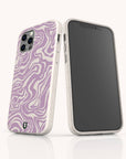 Two smartphones featuring the Purple Marble Swirl Eco-Friendly Phone Case stand upright on a white surface—one facing forward to show the screen, and the other turned to reveal the eye-catching purple marble swirl pattern and camera lenses on its eco-friendly white case.
