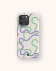 A Purple and Green Swirls Eco-Friendly Biodegradable Phone Case in beige, designed with wavy green and purple lines arranged in an abstract pattern, is displayed on a smartphone against a plain white background.