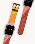 On a light background, two smartwatches showcase the Abstract Cut Out II Vegan Leather Apple Watch Bands, which boast trendy geometric patterns in shades of orange, yellow, and red. The watch faces feature a simple analog clock on black backgrounds.
