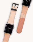 Two Valleys Vegan Leather Apple Watch bands in beige and peach are displayed against a light background. They feature minimalistic black faces with simple hour and minute hands, embracing an eco-friendly design ethos.