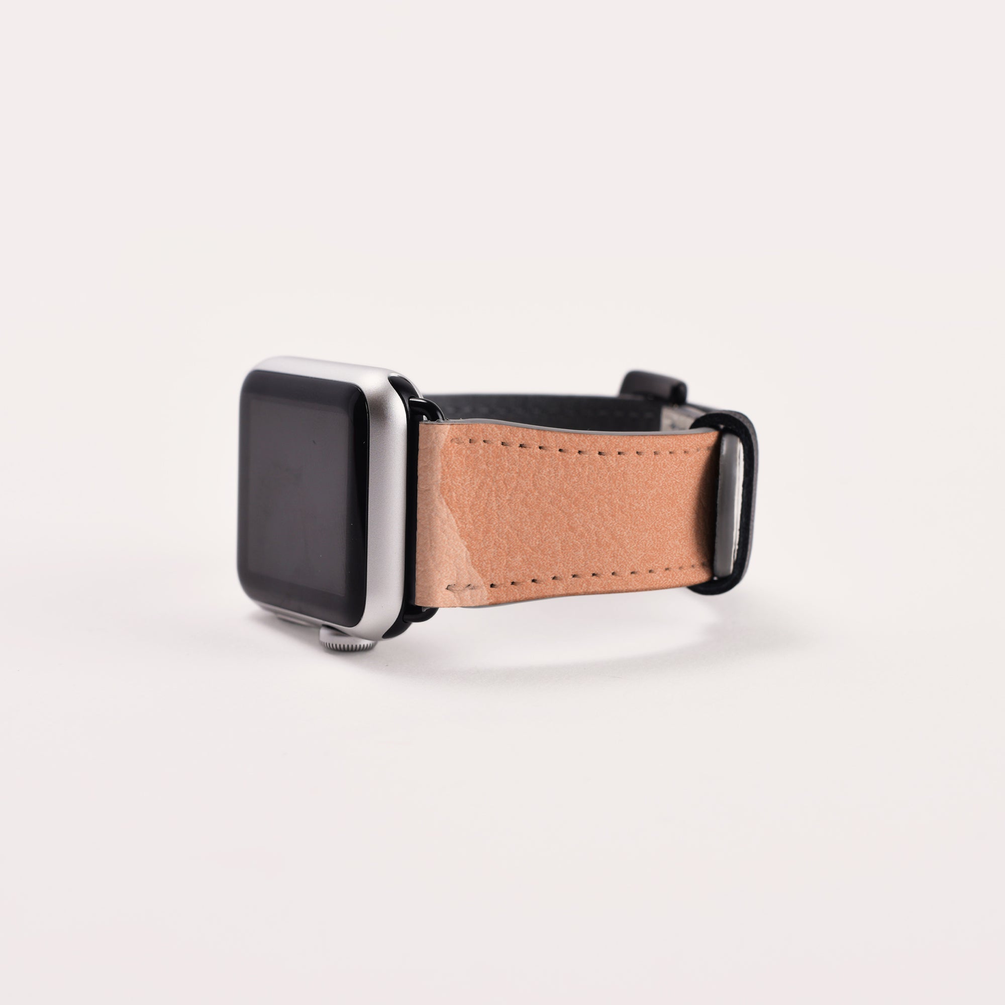 Displayed on a white background is the Abstract Cut Out Vegan Leather Apple Watch Band, featuring a rectangular black screen and a cruelty-free faux leather strap. The watch face is turned off, highlighting the sleek design and elegant band.