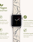 A Black Swirl Lines Vegan Leather Apple Watch Band is wrapped around a smartwatch, with text highlighting its features: cruelty-free, water-resistant, made to order, and certified quality. The band showcases an abstract design using eco-friendly materials, accompanied by green icons for each feature description.