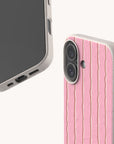 Two views of a Blush Wave Stripe Eco-Friendly Biodegradable Phone Case, featuring a light-colored, speckled design with vertical pink stripes and thin, wavy lines.