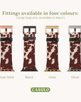 Image featuring four Brown Cow Vegan Leather Apple Watch Bands in rose gold, black, gold, and silver tones. Each band has a rustic appeal with its brown and white cow-print pattern and includes a black strap loop. The text above states, "Fittings available in four colors (strap loop only available in black).