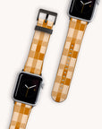 Apple Watch with a Brown Watercolour Checker Vegan Leather band, shown from two angles on a light background. The watch face features a minimalist design with a black background and simple time display.