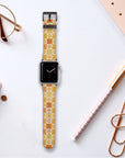 The Brown Flower Check Vegan Leather Apple Watch Band rests on a white desk, surrounded by rose gold stationery, a pen, glasses, and a notebook.