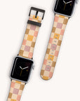 Two smartwatches showcased with the Brown and Purple Checker Vegan Leather Apple Watch Band, featuring a blend of beige, cream, pink, and brown hues against a light background. The watches boast minimal clock faces with an elegant design crafted from vegan leather for sustainable craftsmanship.