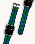 The display features two Green Blue Stripes Vegan Leather Apple Watch Bands. One band is buckled, highlighting its eco-friendly green and blue stripes, while the other shows its entire vegan leather strap. Both bands are paired with watches that have black screens and minimalist clock face designs reminiscent of an Apple Watch band aesthetic.