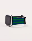 A smartwatch with a silver casing and rectangular face featuring a blank screen is paired with the Green Blue Stripes Vegan Leather Apple Watch Band, which features eco-friendly materials and dark green and blue accents for a sporty look. The watch is placed elegantly on a plain white surface.