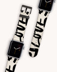 Two "Love Words Vegan Leather" Apple Watch Bands featuring white straps with black graffiti-style lettering spelling "LOVE" display the time as 9 o’clock. Set against a plain light background, these bands offer a sustainable choice for style-conscious consumers.