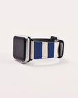 Displayed against a plain white background is a smartwatch with a blank screen, featuring the Navy Stripes Vegan Leather Apple Watch Band, which has navy blue and white vertical stripes.