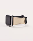 The Neutral Abstract Vegan Leather Apple Watch Band, featuring a chic beige strap and black screen in a square-face design, is showcased on a neutral white background.