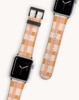 The Pink Watercolour Checker Vegan Leather Apple Watch Band comes with two interchangeable bands in shades of pink, peach, and cream and complements a dark screen featuring a minimalist clock face.
