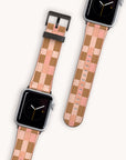 Displayed on a light background are two Apple Watches with the Tan Watercolour Checker Vegan Leather bands in pink and tan, featuring an analog display. The image shows both top and bottom views of the watches.