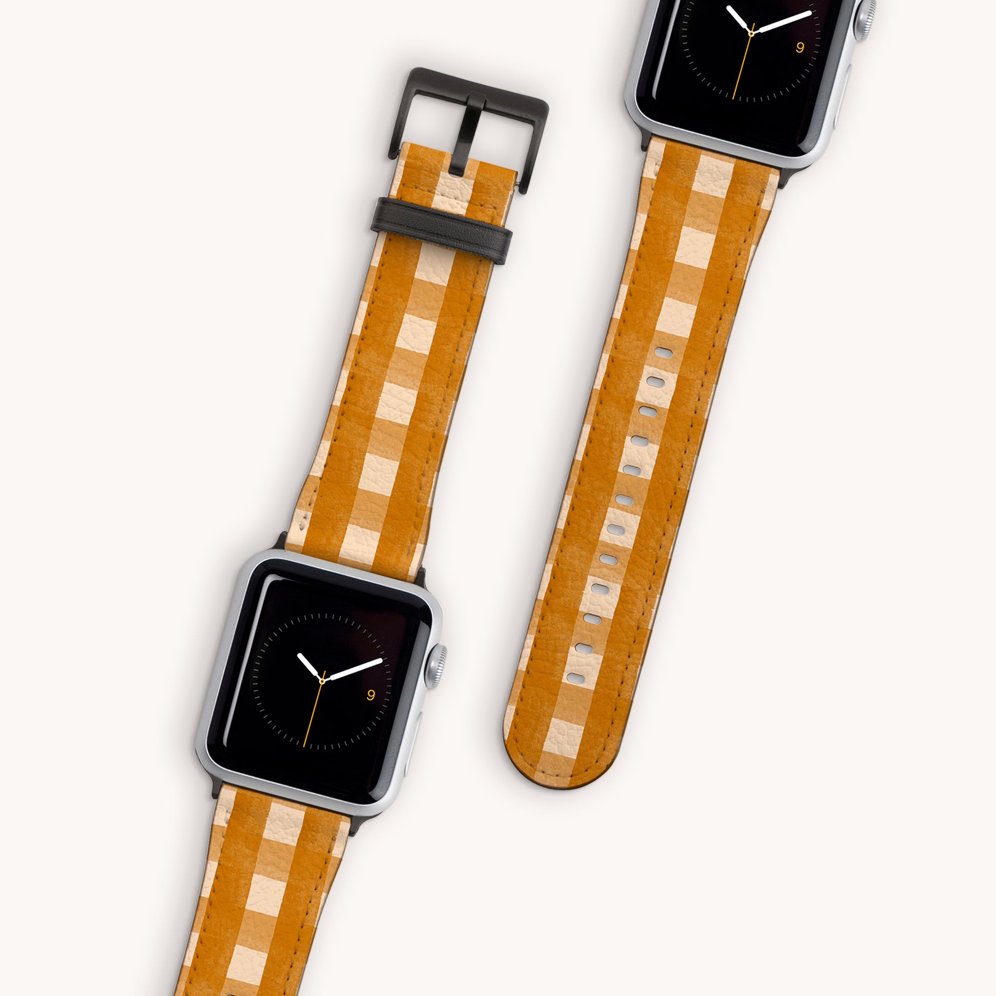 Displayed on a white background, two smartwatches showcase Terracotta Gingham Vegan Leather Apple Watch Bands. Their faces feature minimalist analog clocks with black backgrounds, complemented by the elegant vegan leather straps.