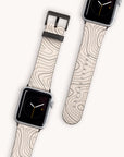 Two Terrain Vegan Leather Apple Watch Bands featuring beige, eco-friendly materials with wavy abstract lines are displayed side by side. The watch displays present a minimalistic clock face on a light background for an elegant presentation.