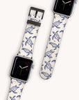 Two smartwatches feature Turtles Vegan Leather Apple Watch Bands with blue sea turtle designs on beige, displaying different times against a white background. This eco-friendly accessory adds oceanic charm to any outfit.