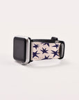 The Wonky Stars Vegan Leather Apple Watch Band features dark blue stars on a white background. Its eco-conscious design adds celestial charm to your wrist while resting gracefully on a light surface.