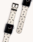 The Xo Xo Vegan Leather Apple Watch Band has a sustainable strap with "XO" patterns, eco-conscious crafting, and a minimalistic analog clock face. It's shown attached to the watch and separately on a light background.