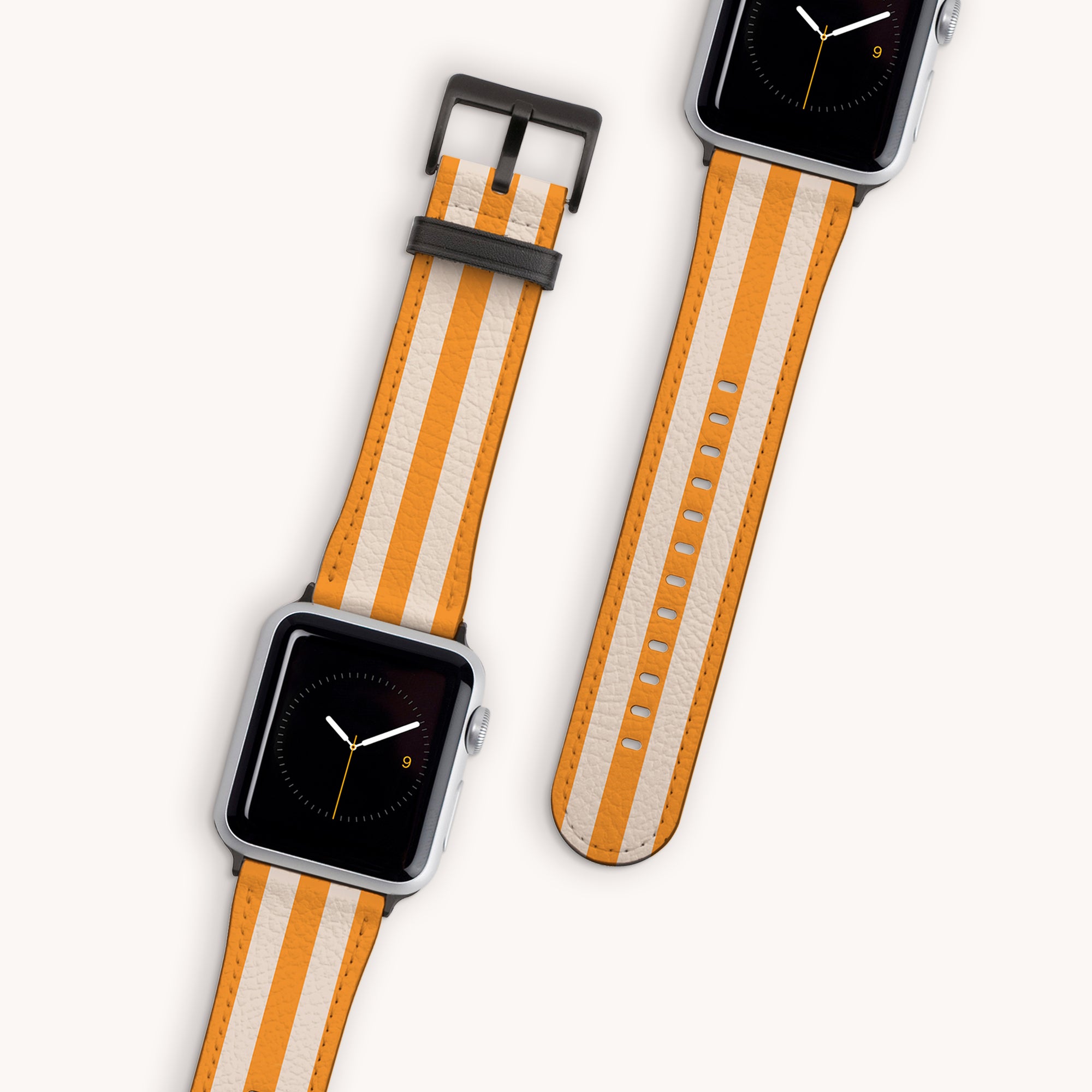 Two smartwatches with the Yellow Beige Stripes Vegan Leather Apple Watch Bands feature minimalistic black faces highlighted with orange accents and are framed in silver. They're displayed on a light background, arranged in varied orientations for a stylish appearance.