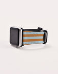 A Brown and Blue Stripes Vegan Leather Apple Watch Band exudes timeless elegance. Suitable for Series 1 to 10, this silver-framed watch features a blank screen against a plain white background.