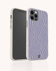 The Blue Distort Lines Eco-Friendly Phone Case, made from biodegradable materials and featuring wavy blue and beige stripes, stands upright on a white background. Compatible with iPhone and Samsung Galaxy devices.