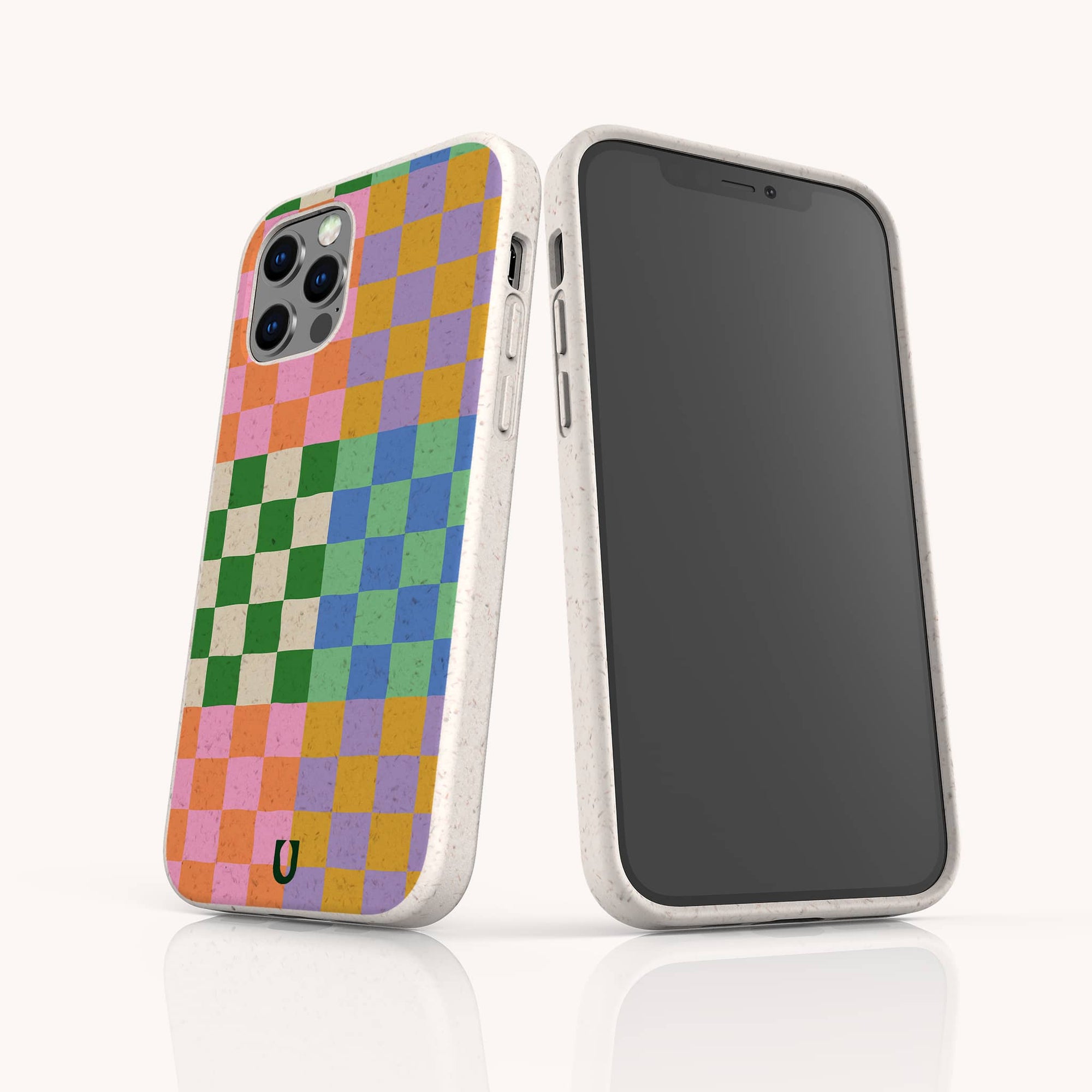 Two smartphones in white speckled Colour Checker Eco-Friendly Phone Cases; one features a colorful pink, yellow, blue, orange, and green checkered pattern, while the other shows a blank screen. Compatible with iPhone and Samsung Galaxy.