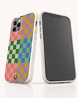 Two smartphones in white speckled Colour Checker Eco-Friendly Phone Cases; one features a colorful pink, yellow, blue, orange, and green checkered pattern, while the other shows a blank screen. Compatible with iPhone and Samsung Galaxy.
