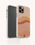 Hills Eco-Friendly Phone Case: A beige, sustainable phone case featuring an abstract design of colorful layered hills in shades of peach, pink, and orange. The back displays a small green and black U logo near the bottom.