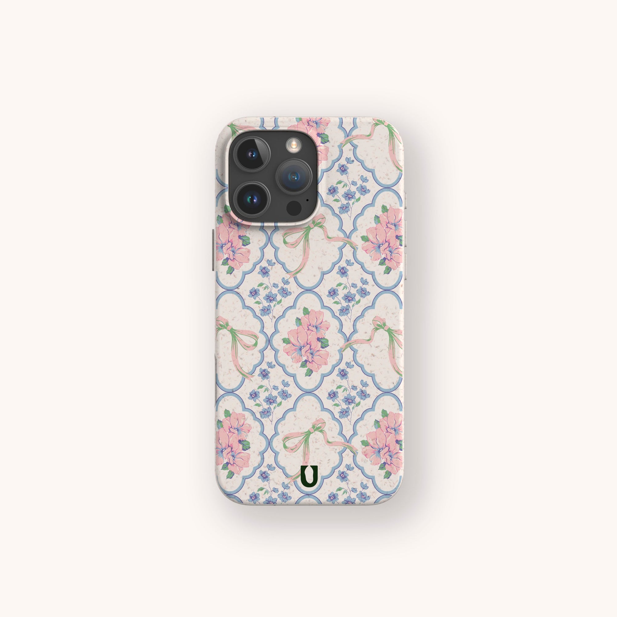The Pink Ribbons Eco-Friendly Biodegradable Phone Case features pink, blue, and green floral ribbons on white, made from eco-friendly materials with a small horseshoe symbol at the bottom.