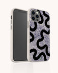 A Speckled Swirl Eco-Friendly Biodegradable Phone Case with a white speckled, plant-based design featuring a black squiggly pattern and dark blue dotted accents, displayed from the front and back against a light background.