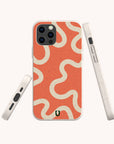 A smartphone in the Orange Swirl Eco-Friendly Biodegradable Phone Case, featuring abstract white and coral wavy lines, is displayed from multiple angles against a plain background.