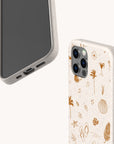 Two beige Summer Jam Eco-Friendly Phone Cases; one displays the screen side, while the other highlights the back adorned with brown beach-themed doodles such as palm trees, shells, sandals, and drinks. Designed with sustainability in mind, these cases combine playful style with an eco-friendly touch.