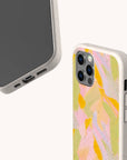 Two Peach Sorbet Eco-Friendly Phone Cases in speckled beige: one displays the phone screen, the other a pastel abstract design. Biodegradable and compatible with iPhone and Samsung Galaxy models.