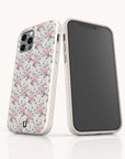 Two smartphones in Pink Coquette Flowers Eco-Friendly Biodegradable Phone Cases—one displays the pastel floral design, the other a plain black screen. Both stand upright on a reflective surface, showcasing sustainable craftsmanship.