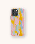 The Bubble Gum Eco-Friendly Phone Case features a colorful abstract pattern with overlapping pink, yellow, and blue brushstrokes on a light background and a small black horseshoe-shaped logo at the bottom.