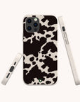 The Cow Print Eco-Friendly Phone Case is displayed from the back and sides, showcasing its texture and button cutouts. Compatible with iPhone and Samsung Galaxy, this stylish accessory blends eco-consciousness with functionality.