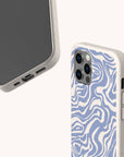 Two smartphones with beige Blue Marble Swirl Eco-Friendly Phone Cases: one shows the front, the other reveals a blue and white marbled back. Both cases feature a speckled texture and precise cutouts for ports and cameras.