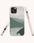 Three angles of the Blue Watercolour Landscape Eco-Friendly Phone Case show its speckled, light-grey biodegradable design with a minimalist blue and grey watercolour landscape. Phone buttons and ports are visible.
