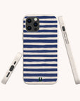 The Navy Stripes Eco-Friendly Biodegradable Phone Case is showcased from several angles, featuring horizontal navy blue and white stripes with a small green logo near the bottom. This slim and protective case combines style, functionality, and sustainability.