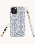 Three views of the Blue Ditsy Flowers Eco-Friendly Biodegradable Phone Case, featuring a blue and purple floral pattern on white, displayed from the back, side, and bottom angles. Made from biodegradable materials.