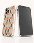 Two smartphones in Pink and Green Watercolour Eco-Friendly Phone Cases, featuring a cream-colored base with a peach, green, and pink checkerboard pattern on the back, stand on a white surface. One phone displays the patterned case; the other shows its blank screen.