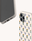 Two smartphones with beige cases are shown. One Sunny Side Up Eco-Friendly Phone Case features a colorful cactus and succulent pattern with yellow and purple accents. The phones are angled to display both the front and back of these eco-friendly phone cases.