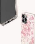 Showcased are two smartphones with eco-friendly beige cases; one reveals the screen, while the other displays the “Pink Roses Eco-Friendly Phone Case” featuring a beautiful pink floral pattern on the back. Both cases have a speckled texture and precise cutouts for buttons and ports.
