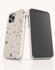 Two smartphones with Brown Terrazzo Eco-Friendly Phone Cases are displayed side by side—one showing the back with a camera cutout, the other showing the front screen. Both eco-friendly cases rest on a light background.