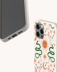 The Sun and the Moon Eco-Friendly Phone Case comes in two styles: one with a minimalist plain front, and another boasting a vibrant celestial design with a sun face, green snakes, stars, and orange and green floral motifs on a white background. Both options are stylish choices that are gentle on the planet.