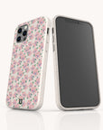 Two smartphones in Coquette Roses Flowers Eco-Friendly Biodegradable Phone Cases with a pink and green floral rose pattern are displayed—one showing the back and the other the front—against a plain light background.