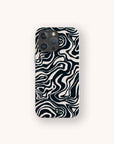 The Black Marble Swirl Eco-Friendly Phone Case features a compostable design with a black and white abstract wavy pattern resembling zebra stripes or marble, set on a light beige background.