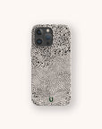 A Mini Strokes Eco-Friendly Biodegradable Phone Case featuring a black and white abstract dotted and wavy pattern is displayed on a plain light background.